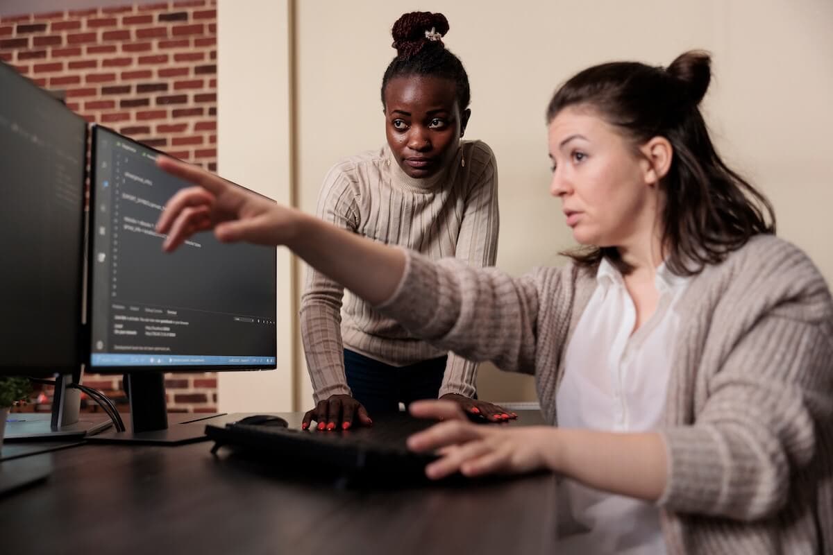 Mentor guiding a student during a programming session
